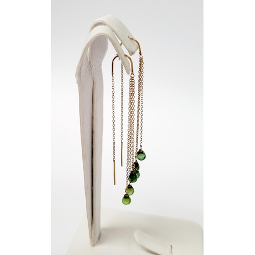 183 - A PRETTY PAIR OF HANGING PERIDOT DROP EARRINGS, each earring with a beautiful trail of peridot stone... 