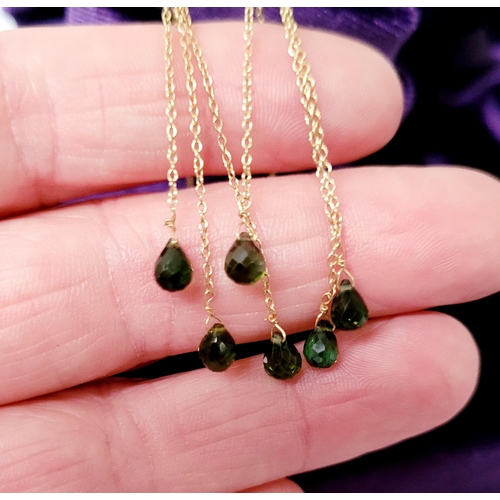 183 - A PRETTY PAIR OF HANGING PERIDOT DROP EARRINGS, each earring with a beautiful trail of peridot stone... 