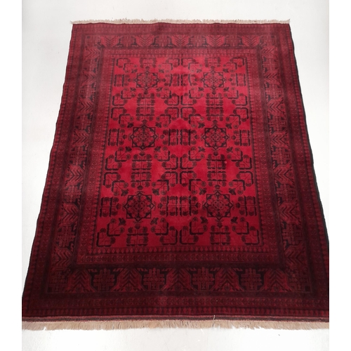 204 - AN AUTHENTIC AFGHAN KHAN MOHAMMADI RUG, hand-woven in the traditional Khan Mohammadi pattern in vibr... 