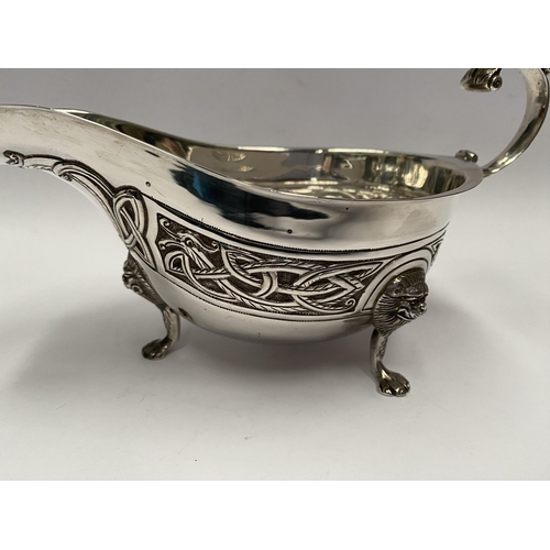 21 - A LARGE IRISH SILVER SAUCE BOAT, Hallmarked H&H (likely Hopkins & Hopkins) Dublin c.1935. Decorated ... 