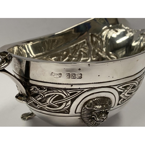 21 - A LARGE IRISH SILVER SAUCE BOAT, Hallmarked H&H (likely Hopkins & Hopkins) Dublin c.1935. Decorated ... 