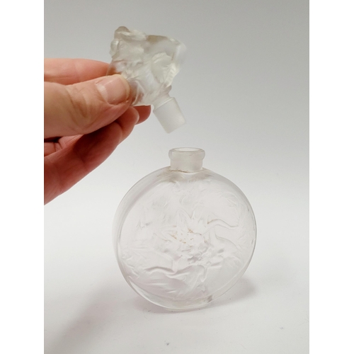 215 - A MID-CENTURY FROSTED PERFUME BOTTLE WITH RAISED RELIEF DESIGN SHOWING INTERTWINED FIGURES, with sto... 