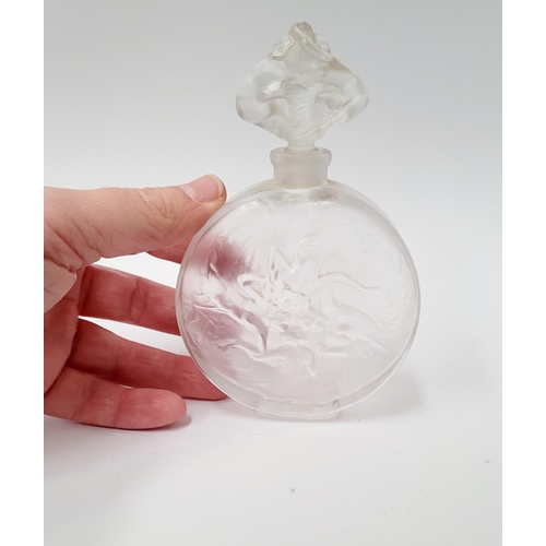 215 - A MID-CENTURY FROSTED PERFUME BOTTLE WITH RAISED RELIEF DESIGN SHOWING INTERTWINED FIGURES, with sto... 