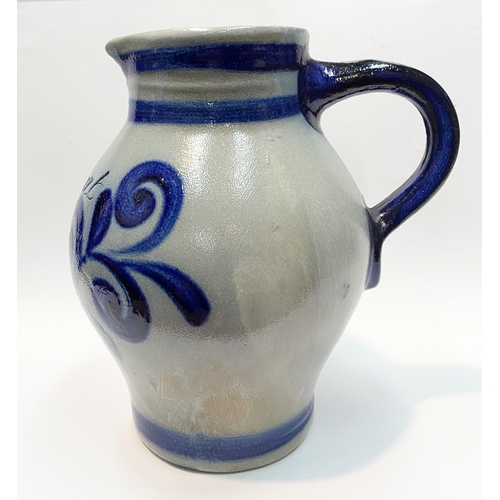 236 - TWO GERMAN SALT GLAZED STONEWARE JUGS, (i) larger pitcher jug with blue painted handle, double band ... 