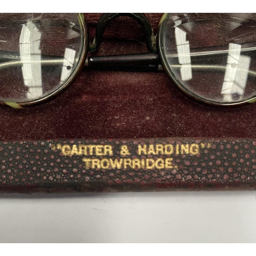 238 - A VINTAGE PAIR OF CASED GLASSES, folding glasses with round frames, the frames having two tones and ... 