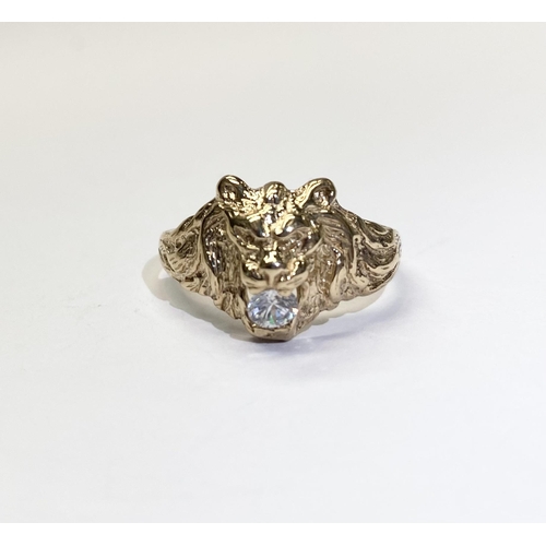 244 - A 9CT YELLOW GOLD LIONS HEAD SIGNET RING, with clear round cut gemstone to mouth, highly detailed li... 