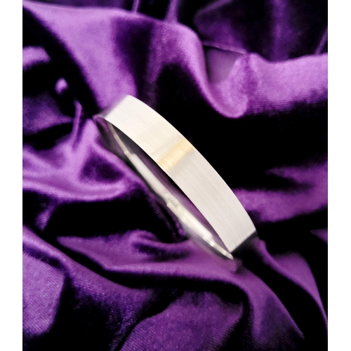 35 - A FINELY CRAFTED COX & POWER STERLING SILVER BANGLE, with brushed finish having a gold coloured stri... 