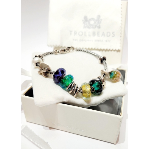 36 - A FANTASTIC TROLLBEADS STERLING SILVER BRACELET WITH CHARMS, presented in original box on a soft rib... 