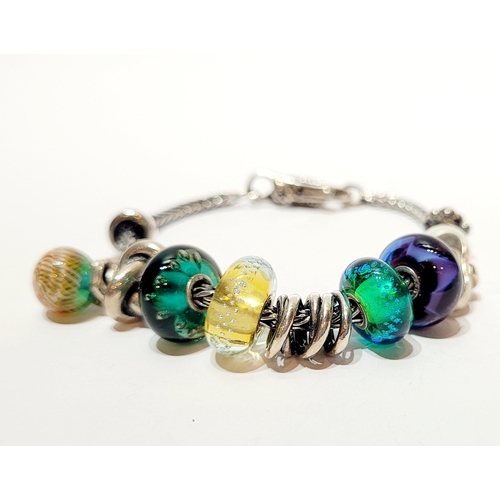 36 - A FANTASTIC TROLLBEADS STERLING SILVER BRACELET WITH CHARMS, presented in original box on a soft rib... 