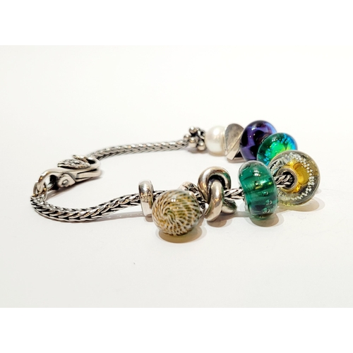 36 - A FANTASTIC TROLLBEADS STERLING SILVER BRACELET WITH CHARMS, presented in original box on a soft rib... 