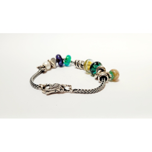 36 - A FANTASTIC TROLLBEADS STERLING SILVER BRACELET WITH CHARMS, presented in original box on a soft rib... 