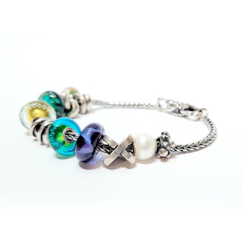 36 - A FANTASTIC TROLLBEADS STERLING SILVER BRACELET WITH CHARMS, presented in original box on a soft rib... 