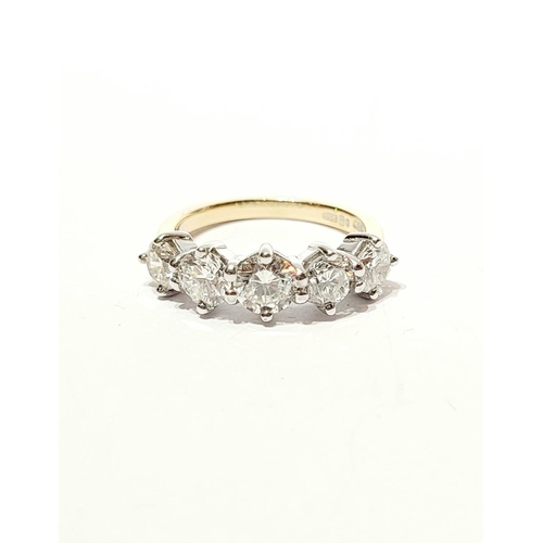 37 - A SPECTACULAR 18CT GOLD FIVE STONE GRADUATED DIAMOND RING, with a central diamond of .6cts, flanked ... 