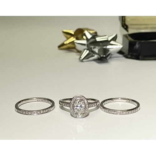 41 - AN EXCEPTIONAL PLATINUM OVAL SOLITAIRE DIAMOND RING WITH TWO PLATINUM THIRTEEN STONE DIAMOND BANDS. ... 