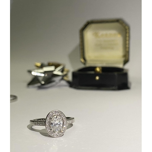 41 - AN EXCEPTIONAL PLATINUM OVAL SOLITAIRE DIAMOND RING WITH TWO PLATINUM THIRTEEN STONE DIAMOND BANDS. ... 