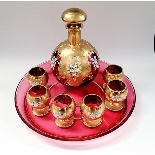 52 - A VINTAGE BOHEMIAN ENAMEL DECORATED DECANTER & GLASS SET, each piece finished with bright gold detai... 