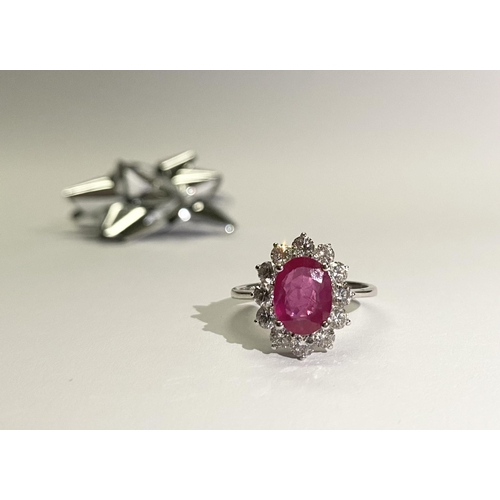 61 - AN EXCEPTIONAL 18CT WHITE GOLD RUBY AND DIAMOND CLUSTER RING, central vibrant ruby in four claw sett... 