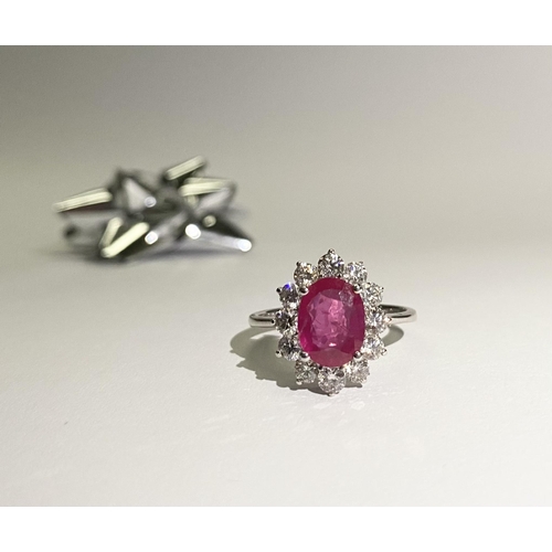 61 - AN EXCEPTIONAL 18CT WHITE GOLD RUBY AND DIAMOND CLUSTER RING, central vibrant ruby in four claw sett... 