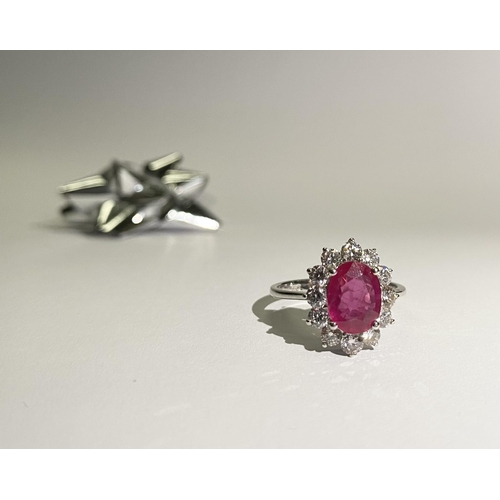 61 - AN EXCEPTIONAL 18CT WHITE GOLD RUBY AND DIAMOND CLUSTER RING, central vibrant ruby in four claw sett... 