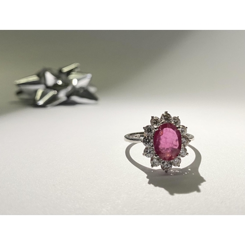 61 - AN EXCEPTIONAL 18CT WHITE GOLD RUBY AND DIAMOND CLUSTER RING, central vibrant ruby in four claw sett... 