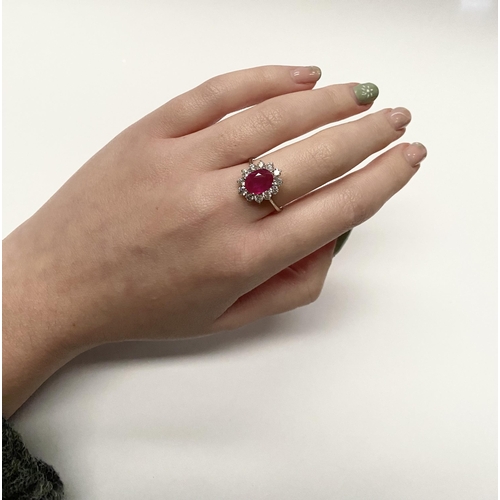 61 - AN EXCEPTIONAL 18CT WHITE GOLD RUBY AND DIAMOND CLUSTER RING, central vibrant ruby in four claw sett... 