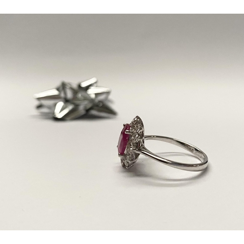 61 - AN EXCEPTIONAL 18CT WHITE GOLD RUBY AND DIAMOND CLUSTER RING, central vibrant ruby in four claw sett... 