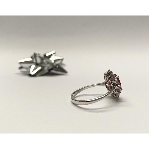 61 - AN EXCEPTIONAL 18CT WHITE GOLD RUBY AND DIAMOND CLUSTER RING, central vibrant ruby in four claw sett... 