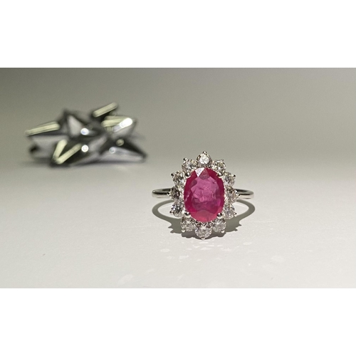 61 - AN EXCEPTIONAL 18CT WHITE GOLD RUBY AND DIAMOND CLUSTER RING, central vibrant ruby in four claw sett... 