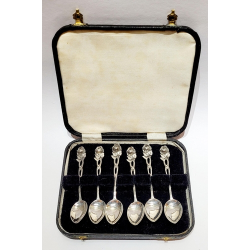 7 - AN EARLY 20TH CENTURY CASED SET OF SILVER ROSE TIPPED TEA SPOONS, each handle with an intertwining r... 