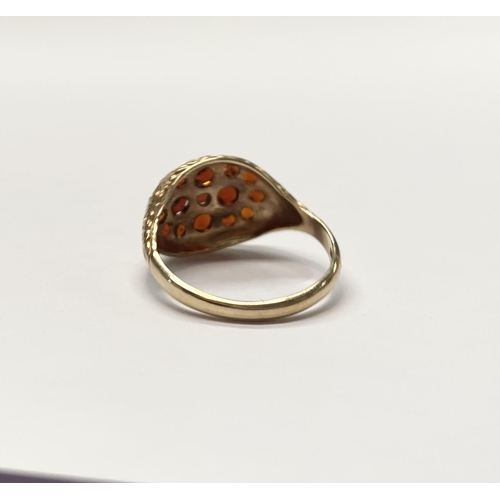 73 - A VINTAGE 9CT YELLOW GOLD GARNET CLUSTER RING, with fifteen round cut garnets of varying sizes claw ... 