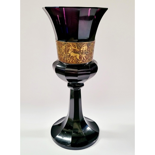 76 - AN ART DECO EARLY 20TH CENTURY MOSER KARLSBAD STYLE AMETHYST GLASS WITH OROPLASTIC GILT BAND DEPICTI... 