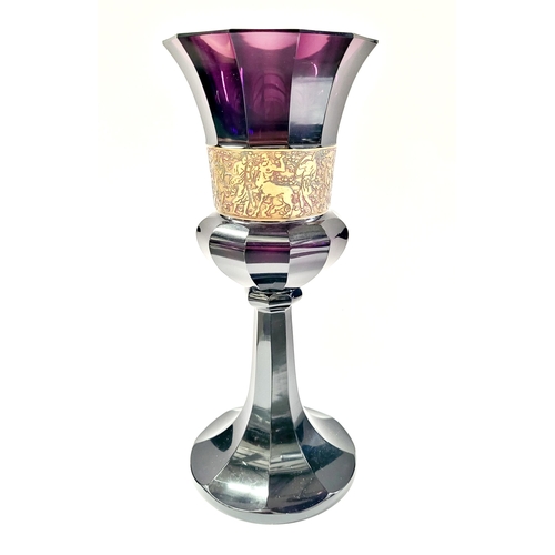 76 - AN ART DECO EARLY 20TH CENTURY MOSER KARLSBAD STYLE AMETHYST GLASS WITH OROPLASTIC GILT BAND DEPICTI... 