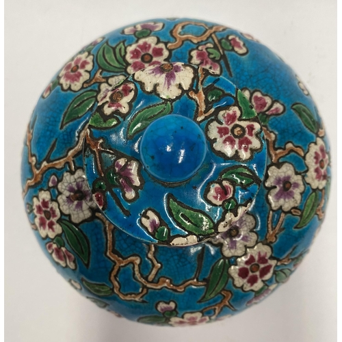 82 - AN EARLY 20TH CENTURY FRENCH POTTERY INKWELL, with cherry blossom design to circular body and cover ... 