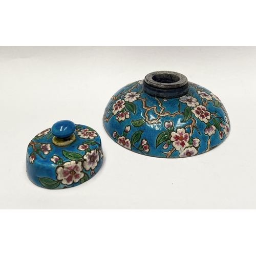 82 - AN EARLY 20TH CENTURY FRENCH POTTERY INKWELL, with cherry blossom design to circular body and cover ... 