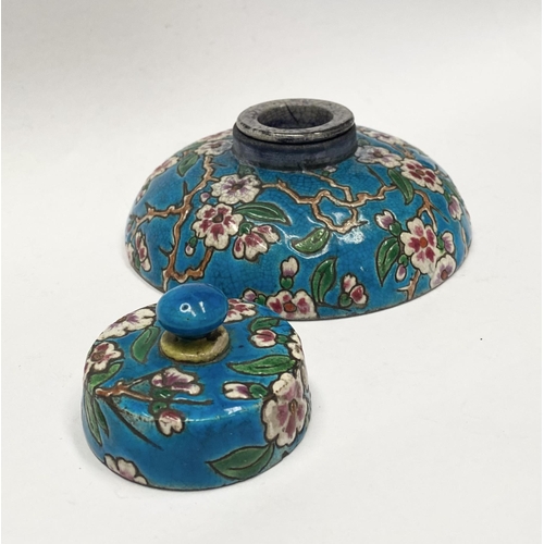 82 - AN EARLY 20TH CENTURY FRENCH POTTERY INKWELL, with cherry blossom design to circular body and cover ... 