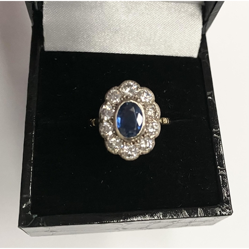 84 - A BEAUTIFUL 18CT YELLOW GOLD SAPPHIRE AND DIAMOND CLUSTER RING, vibrant oval cut bezel set sapphire ... 