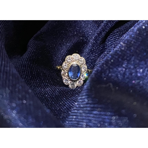 84 - A BEAUTIFUL 18CT YELLOW GOLD SAPPHIRE AND DIAMOND CLUSTER RING, vibrant oval cut bezel set sapphire ... 