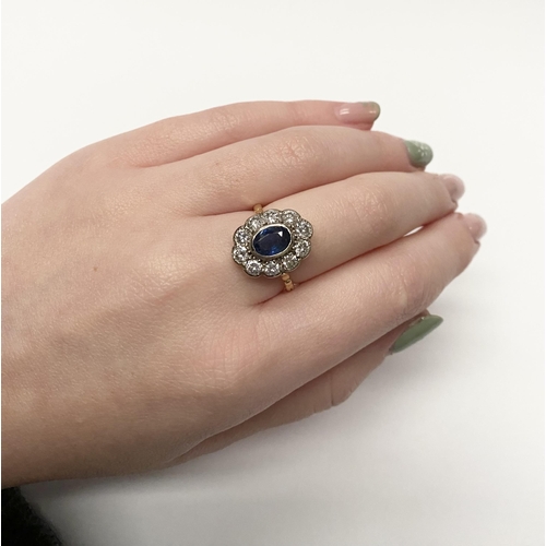 84 - A BEAUTIFUL 18CT YELLOW GOLD SAPPHIRE AND DIAMOND CLUSTER RING, vibrant oval cut bezel set sapphire ... 