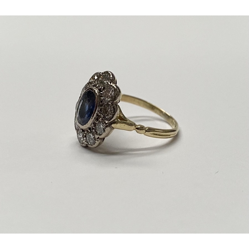 84 - A BEAUTIFUL 18CT YELLOW GOLD SAPPHIRE AND DIAMOND CLUSTER RING, vibrant oval cut bezel set sapphire ... 