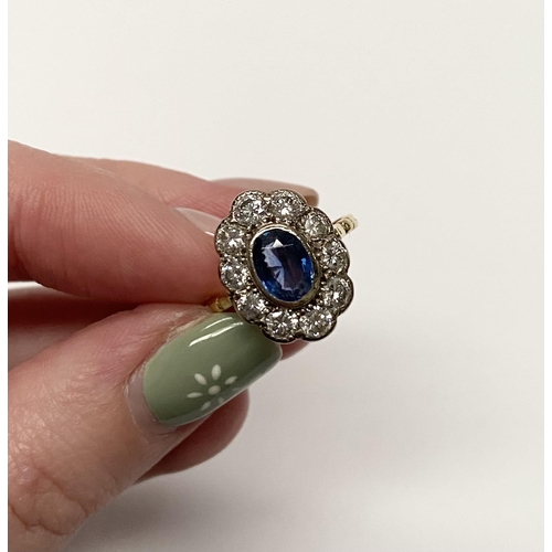 84 - A BEAUTIFUL 18CT YELLOW GOLD SAPPHIRE AND DIAMOND CLUSTER RING, vibrant oval cut bezel set sapphire ... 