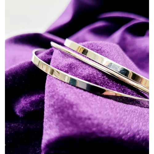 94 - A STUNNING TRIO OF 18CT WHITE GOLD BANGLE BRACLETS, each hallmarked; 18ct white gold. 750. 6cm wide.