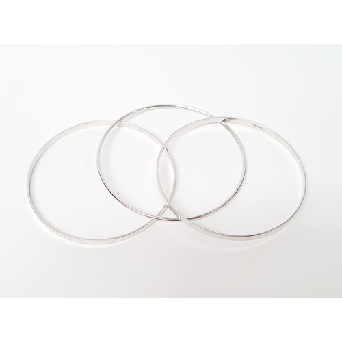 94 - A STUNNING TRIO OF 18CT WHITE GOLD BANGLE BRACLETS, each hallmarked; 18ct white gold. 750. 6cm wide.