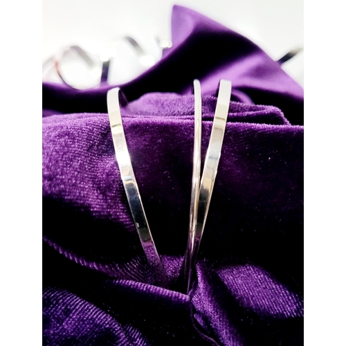 94 - A STUNNING TRIO OF 18CT WHITE GOLD BANGLE BRACLETS, each hallmarked; 18ct white gold. 750. 6cm wide.