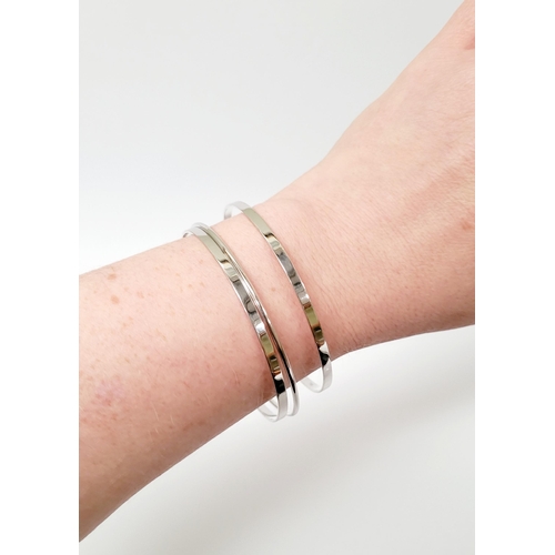 94 - A STUNNING TRIO OF 18CT WHITE GOLD BANGLE BRACLETS, each hallmarked; 18ct white gold. 750. 6cm wide.