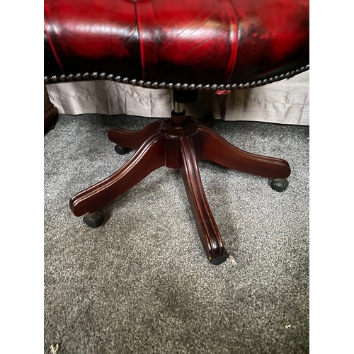 214 - AN EXCELLENT OXBLOOD RED LEATHER DESK/CAPTAINS CHAIR, with button back design to oxblood red leather... 