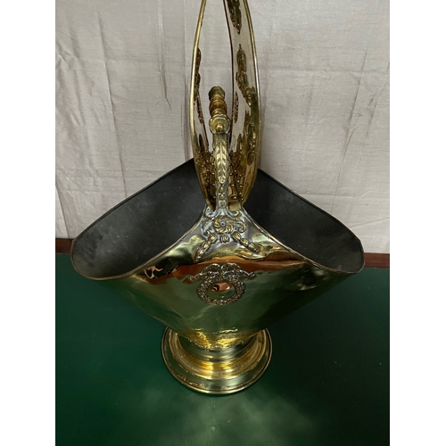 259 - A VICTORIAN EMBOSSED BRASS DOUBLE SIDED COAL SCUTTLE, with handle to top, double opening to top each... 