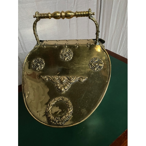 259 - A VICTORIAN EMBOSSED BRASS DOUBLE SIDED COAL SCUTTLE, with handle to top, double opening to top each... 