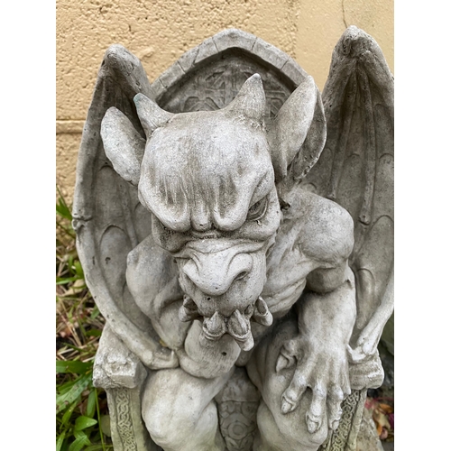 280 - A STONE GARDEN FIGURE IN THE FORM OF SEATED GARGOYLE, dimensions: 49cm high