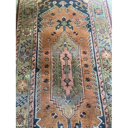 104 - A FINE VINTAGE TURKISH RUG, handwoven with central medallion motif surrounded by multiple borders an... 