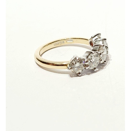 110 - A SPECTACULAR 18CT GOLD FIVE STONE GRADUATED DIAMOND RING, with a central diamond of .6cts, flanked ... 